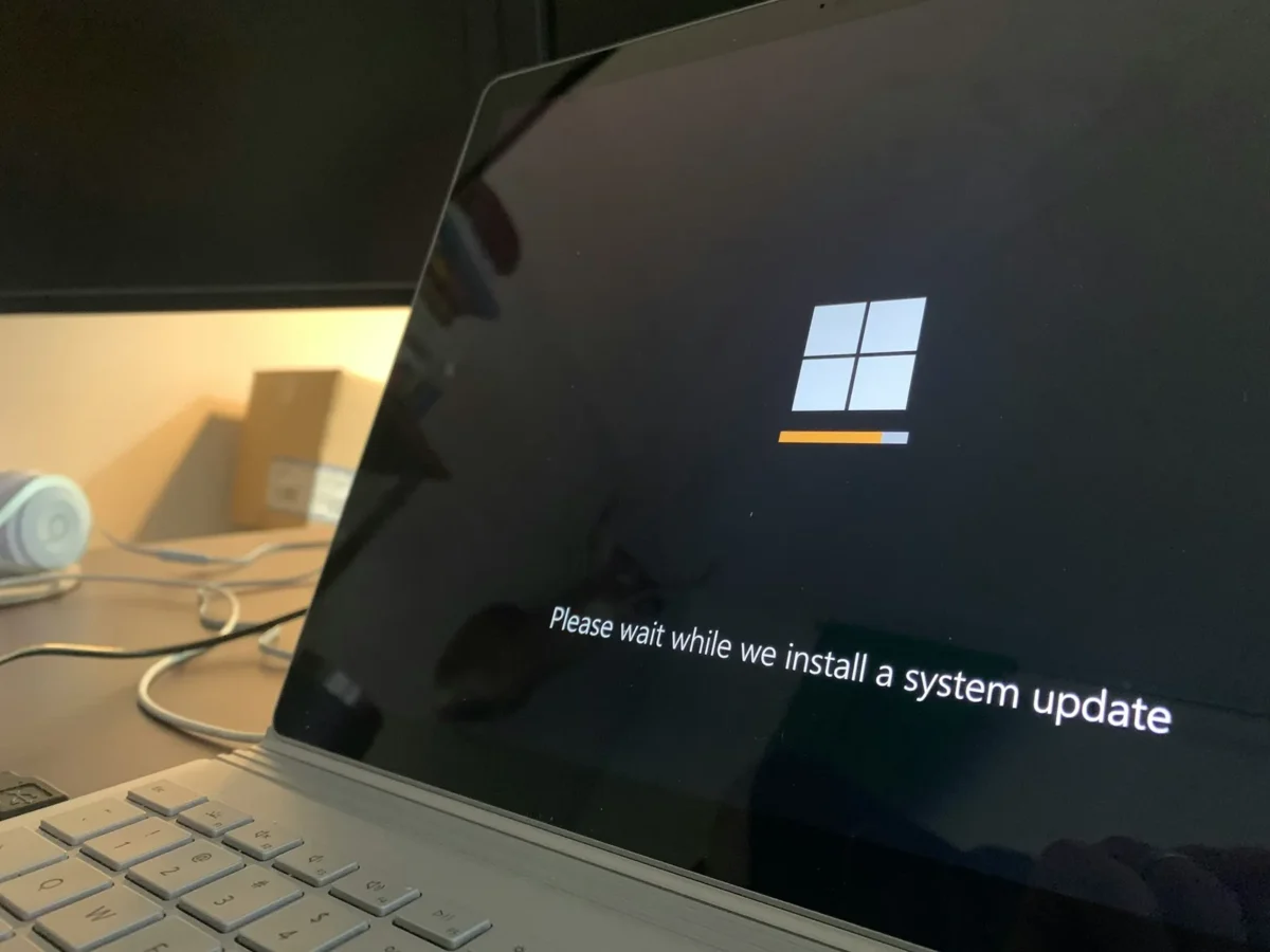 How to Update Windows: 5 Fixes for Stuck Updates in 2026 An infographic titled "How to Update Windows — A Complete Step-by-Step Guide for Windows 10 & 11" for TechBhavik. It features a technical blue circuit board design and outlines three main steps: 1) System Pre-checks (internet, storage, and disabling conflicting apps), 2) Comparison of Windows 10 and 11 update settings, and 3) The full update process from scanning to verification.
