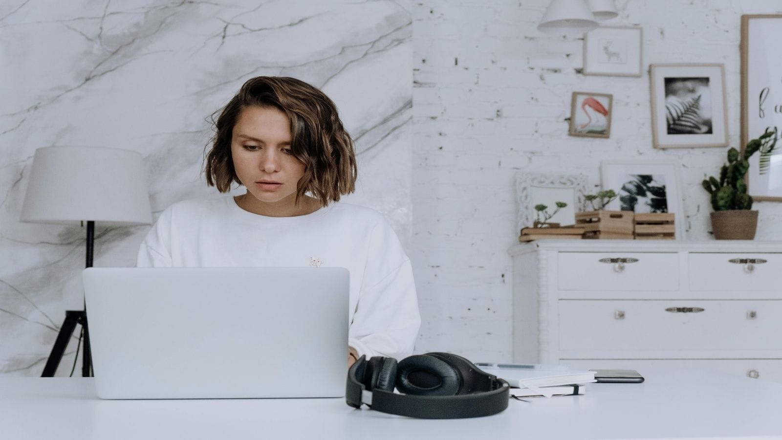 Websites That Pay You Online- A professional woman working on a laptop at her desk, representing remote freelancers earning money from websites that pay you online.