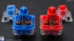 Best Wired Keyboard for Fast Typing in India (2026 Guide) Close-up of blue and red mechanical switches showing the internal spring and copper contacts