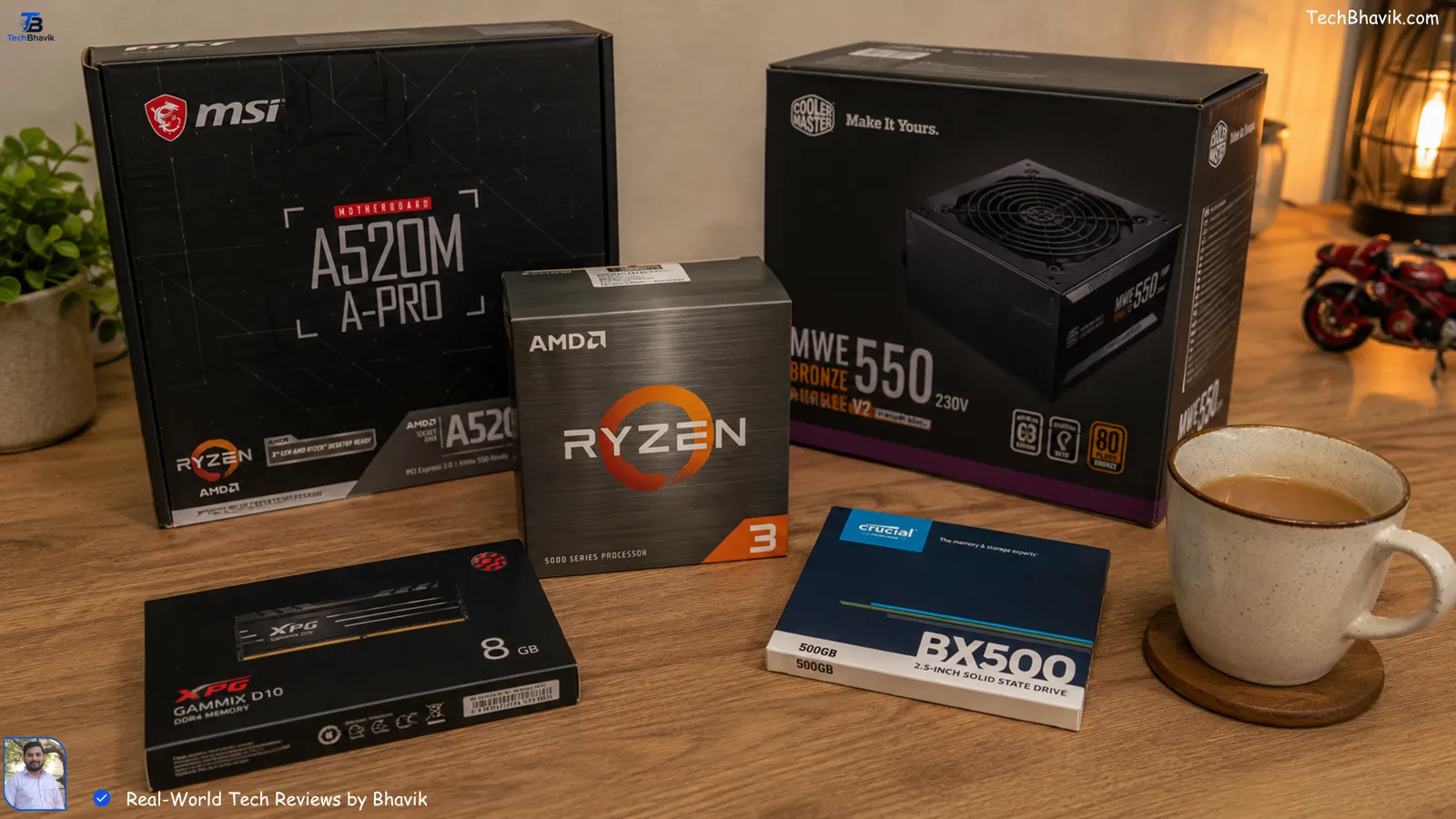 pc setup A collection of PC component boxes like Ryzen 3 and Crucial SSD on a wooden table with a cup of tea