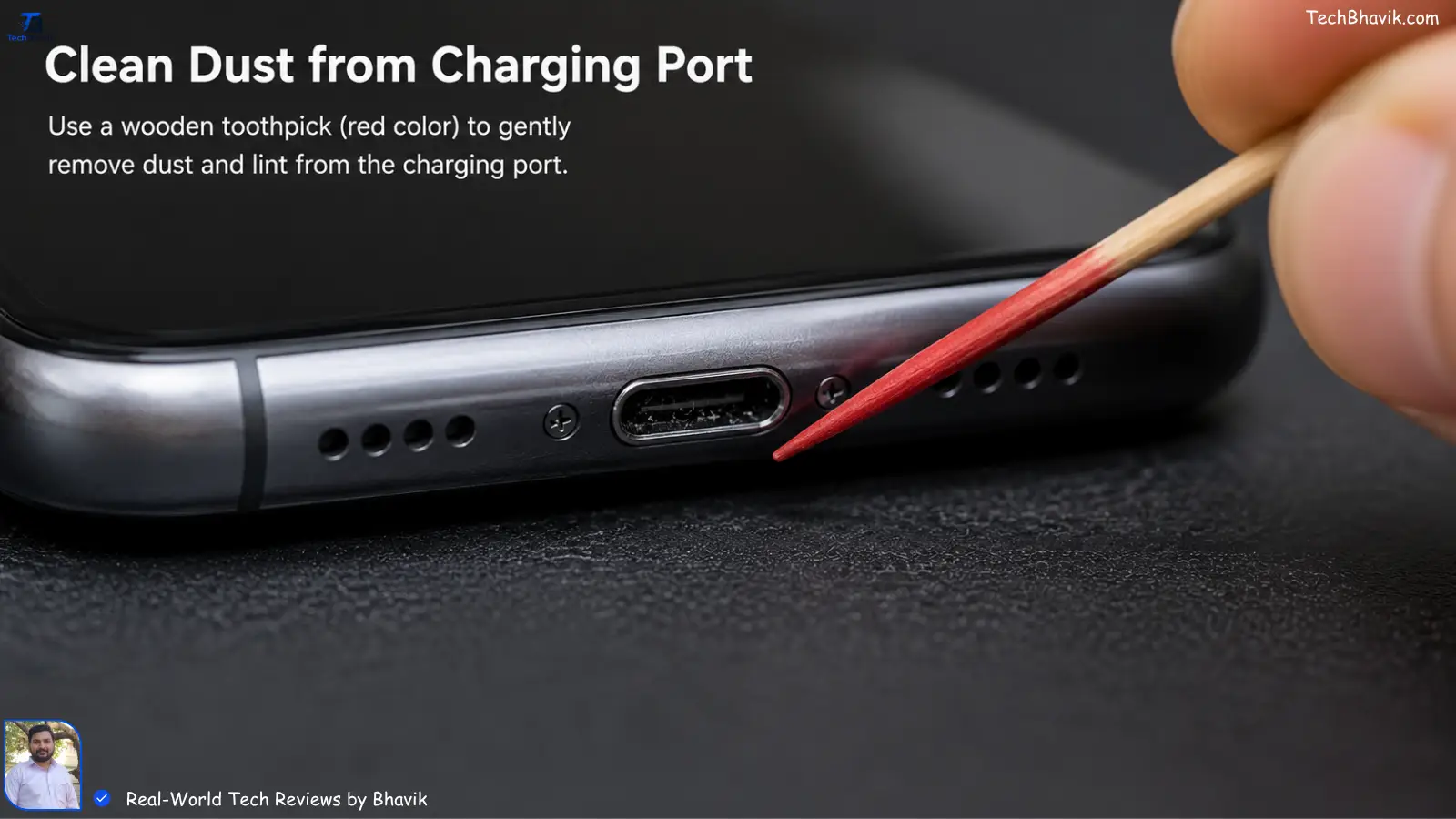Close-up of a wooden toothpick removing dust from a smartphone charging port