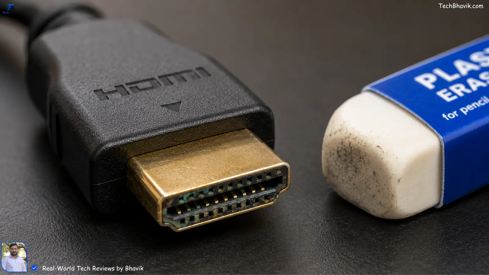 Close up of an HDMI cable with slight oxidation on the pins and an eraser nearby